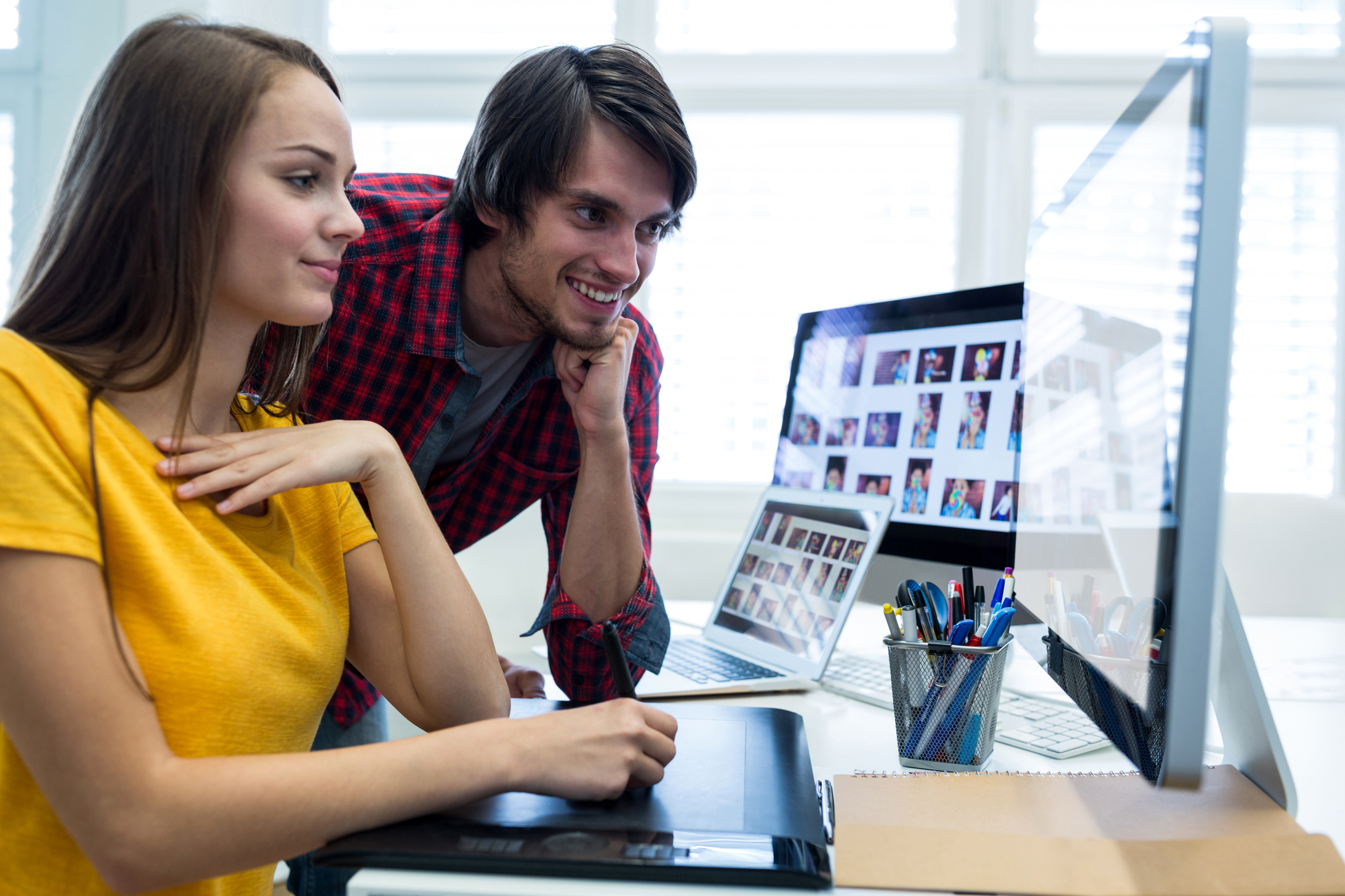 male-female-graphic-designers-using-graphics-tablet